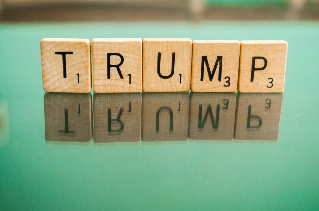 Trump spelled out in scrabble tiles reflected on a mirror